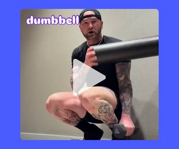 A tattooed man in workout gear squats while holding a dumbbell in one hand and resting a foam roller on his shoulder. The word “dumbbell” is written in playful purple and white text in the top-left corner.