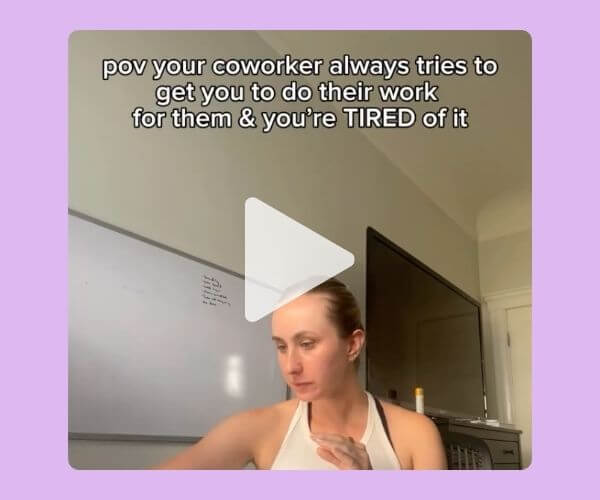 Screenshot of a woman sitting at a desk looking frustrated, with the caption: “pov your coworker always tries to get you to do their work for them & you’re TIRED of it,” overlaid on a pastel purple background. A play button indicates it’s a video.