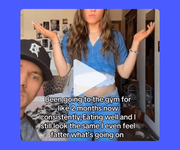  A woman in a blue top gestures in confusion with text overlaid saying, “Been going to the gym for like 2 months now consistently, eating well and I still look the same I even feel fatter what’s going on,” while a man peeks in from the corner.