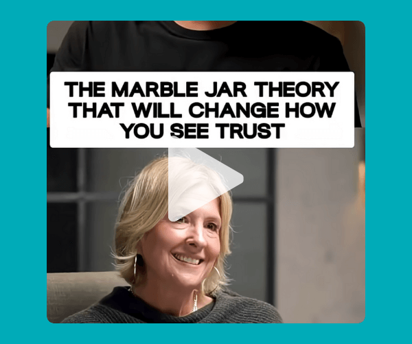  A video still shows a smiling woman seated and talking, with text above her that reads, “The Marble Jar Theory That Will Change How You See Trust.”
