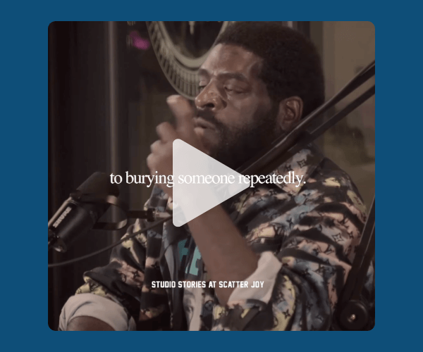 A man sits in front of a podcast mic mid-conversation, his hand raised as on-screen text overlays the emotional topic being discussed.