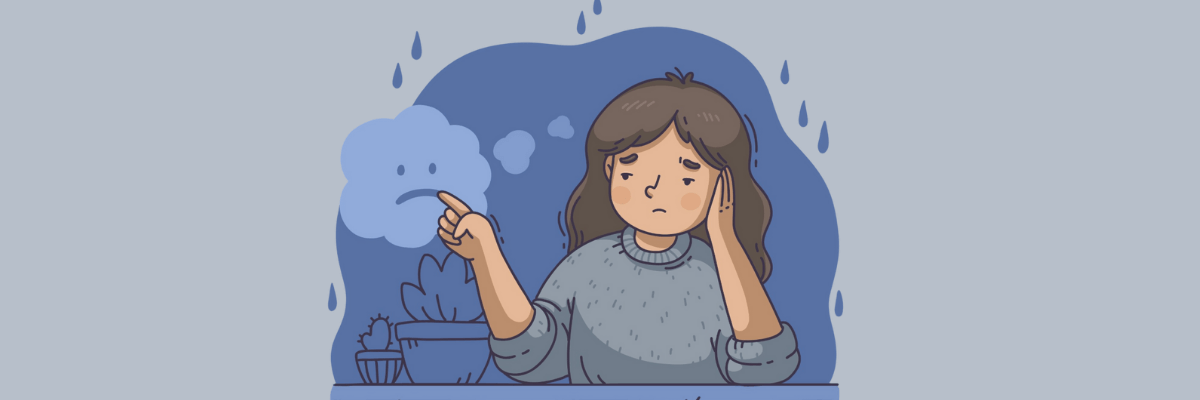An illustration of a sad-looking woman resting her head on her hand while sitting at a table. She’s touching a small cloud with a frown on its face as raindrops fall around her, symbolizing feeling down or gloomy.