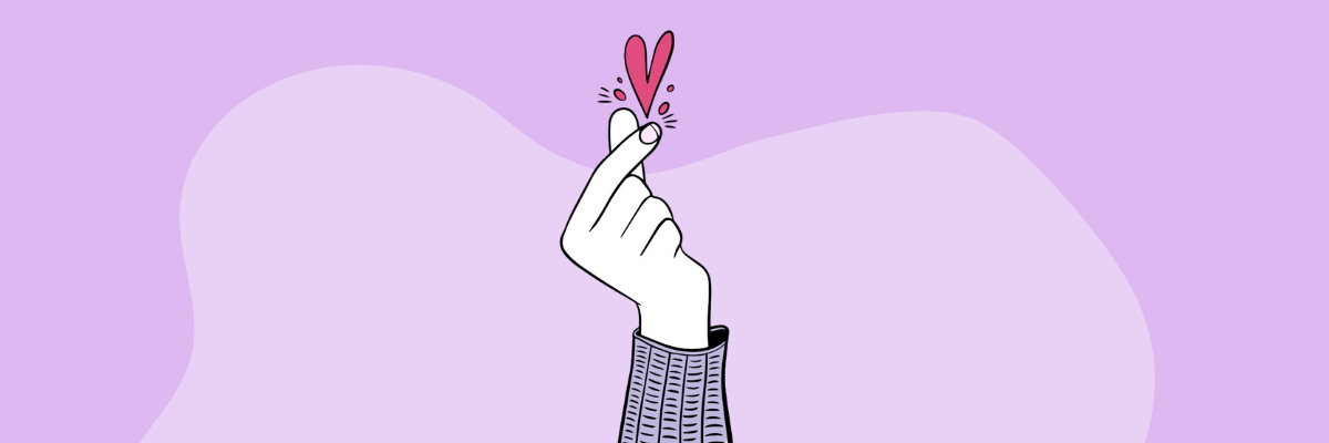 A soft lavender background with rounded, abstract shapes sets a calm, minimal mood. In the center, a hand makes a finger-heart gesture, with a small pink heart popping above the fingers for a playful, affectionate touch.