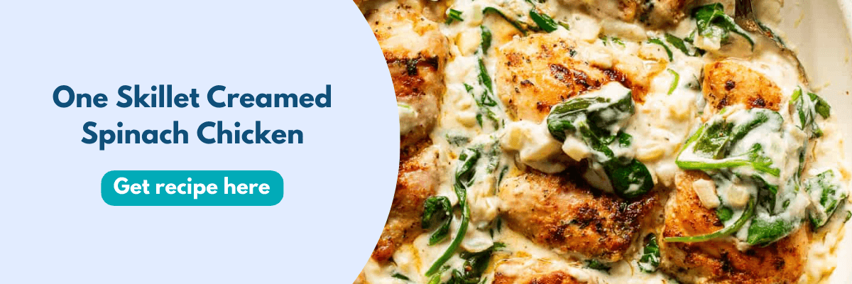 A creamy skillet of golden-brown chicken mixed with wilted spinach sits on the right, looking super cozy and delicious. On the left, bold text reads “One Skillet Creamed Spinach Chicken” with a button to get the recipe.