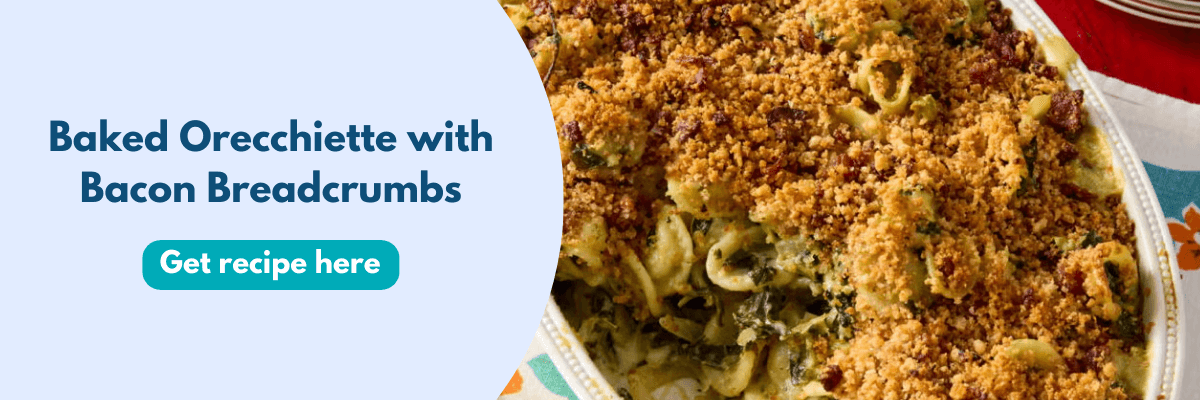 A close-up of a baked orecchiette pasta dish topped with crispy bacon breadcrumbs sits alongside text that says “Baked Orecchiette with Bacon Breadcrumbs” and a button to get the recipe. It looks golden, cozy, and delicious.