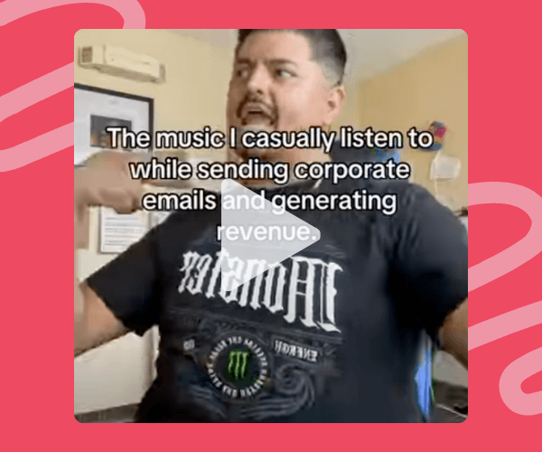 The text reads, “The music I casually listen to while sending corporate emails and generating revenue.” The image shows a man mid-motion indoors, framed by a bright pink background with wavy accents that give it a playful, meme-style feel.