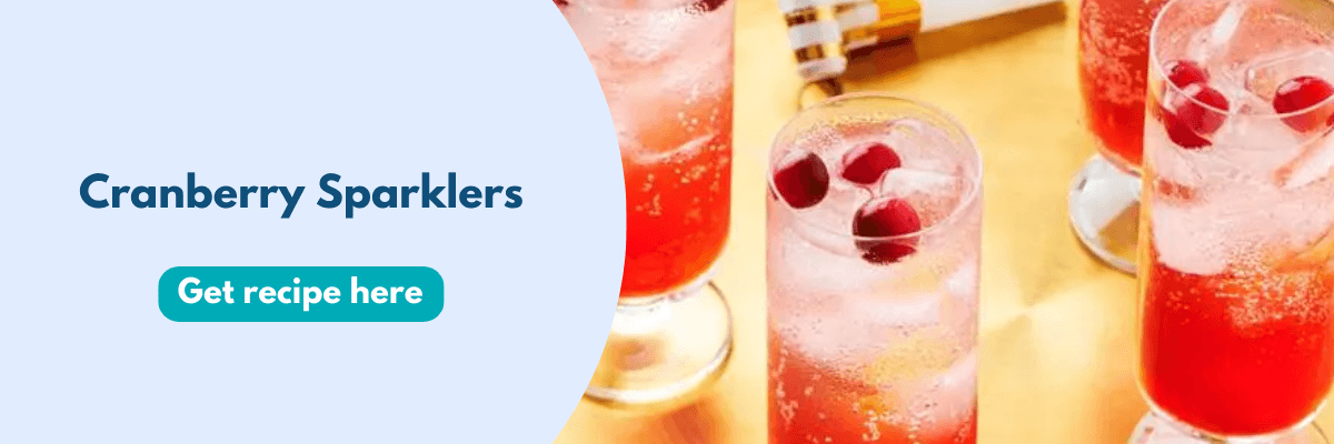 Close-up of tall glasses filled with fizzy cranberry cocktails, garnished with fresh cranberries and ice, set against a bright, festive backdrop.