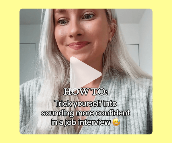 Screenshot from a selfie-style video of a woman smiling softly at the camera, with on-screen text that reads, “How to: Trick yourself into sounding more confident in a job interview.” The video sits within a pale yellow overlay background.