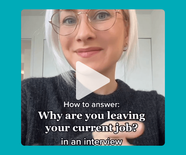 A close-up of a woman wearing glasses speaking to camera with a play button overlay, styled like a short video. Text on screen discusses how to answer why you’re leaving your current job in an interview, set against a simple indoor background.