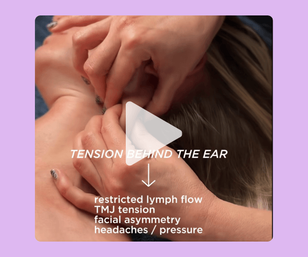 A close-up wellness-style video image showing hands massaging the area behind a person’s ear and neck. Overlaid text explains tension points and related issues like headaches and facial asymmetry, set on a soft purple background.