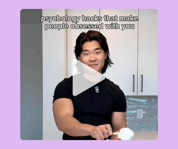 A video still features a man in a kitchen setting with text reading “psychology hacks that make people obsessed with you.” He faces the camera mid-explanation with a play button overlay.