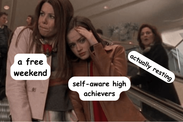 Two women ride an escalator in a busy indoor setting, both looking slightly stressed—one glances to the side while the other holds her head as if overwhelmed. Overlaid text labels read “a free weekend,” “self-aware high achievers,” and “actually resting,” humorously suggesting the tension between wanting rest and struggling to truly relax.