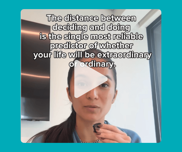 Video screenshot of a woman speaking with overlaid text saying, “The distance between deciding and doing is the single most reliable predictor of whether your life will be extraordinary or ordinary.”