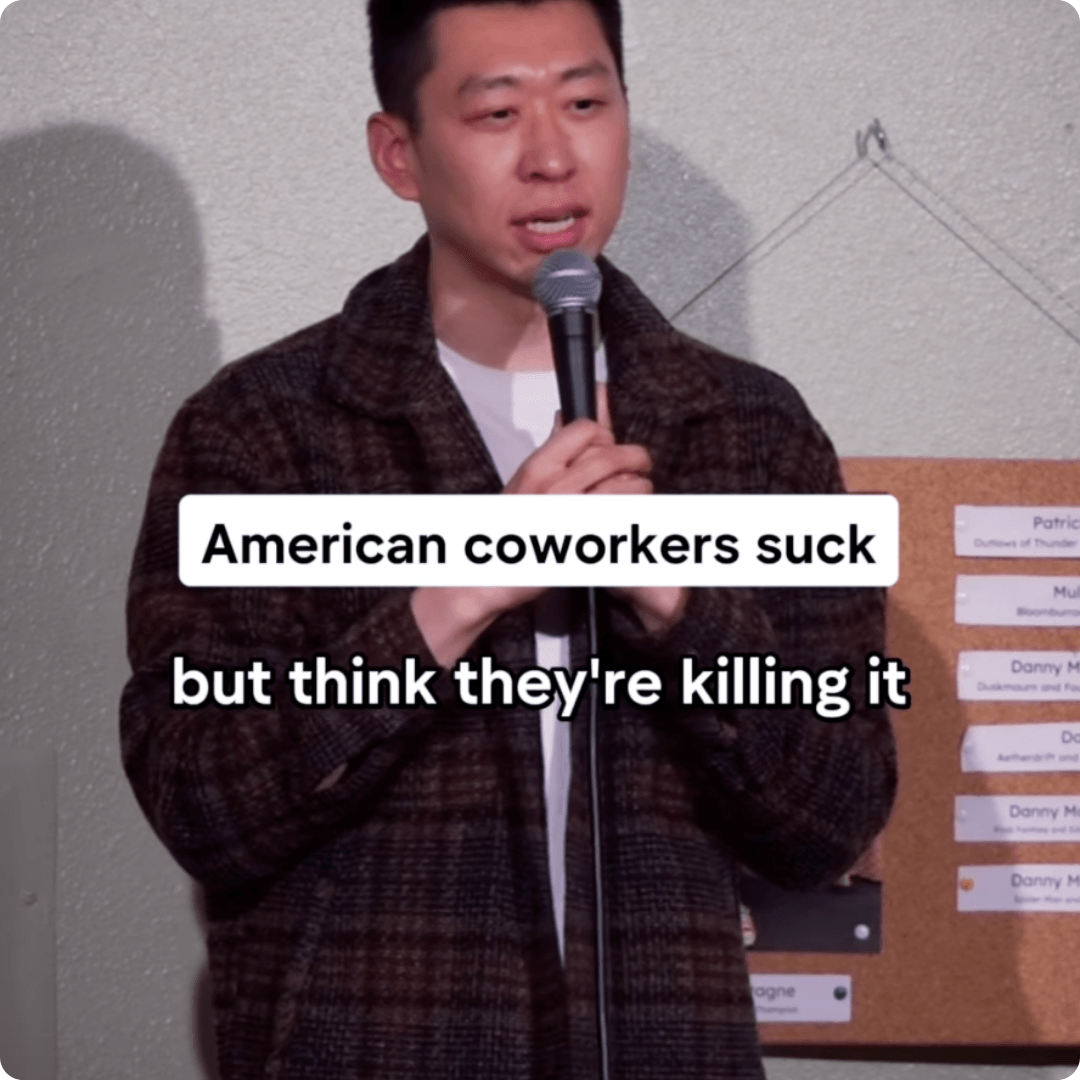 A meme shows a man speaking into a microphone with text that says, “American coworkers suck but think they’re killing it.” A corkboard with pinned notes is visible in the background.