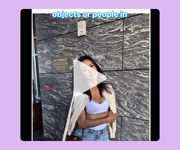 A video thumbnail shows a woman standing in front of a gray marble wall while explaining how to remove unwanted objects or people from photos. A large play button overlays the center of the image.
