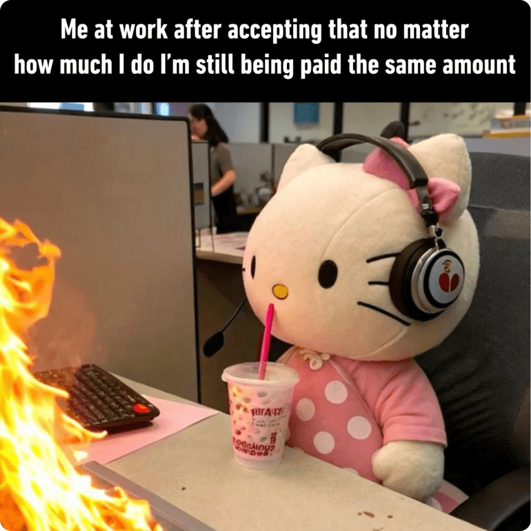 A Hello Kitty plush sits calmly at an office desk while a keyboard burns nearby, creating a humorous contrast. The meme jokes about staying unbothered at work despite chaos happening around you.