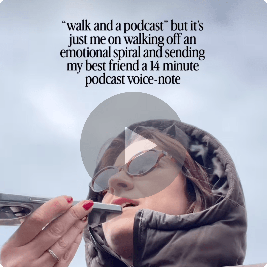 A woman wearing sunglasses and a dark hooded jacket holds a smartphone close to her mouth while outdoors under a cloudy sky. Large text appears above her, and a video play icon overlays the center of the image.