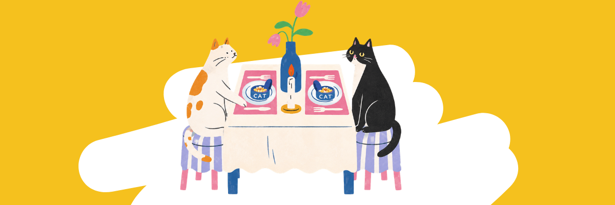 An illustration depicts two cats seated across from each other at a small dining table. Each cat sits on a stool with a bowl of food in front of them, while a candle and flower vase sit in the center of the table.