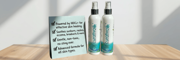 Two skincare spray bottles are displayed beside a sign listing benefits such as soothing irritation and supporting skin healing. The product presentation emphasizes gentle, everyday care for a variety of skin concerns.