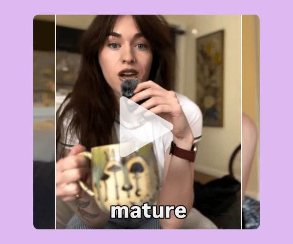 A video thumbnail shows a woman holding a microphone and a patterned mug while speaking to the camera in a home setting. A large play button appears in the center, with the word “mature” displayed at the bottom.