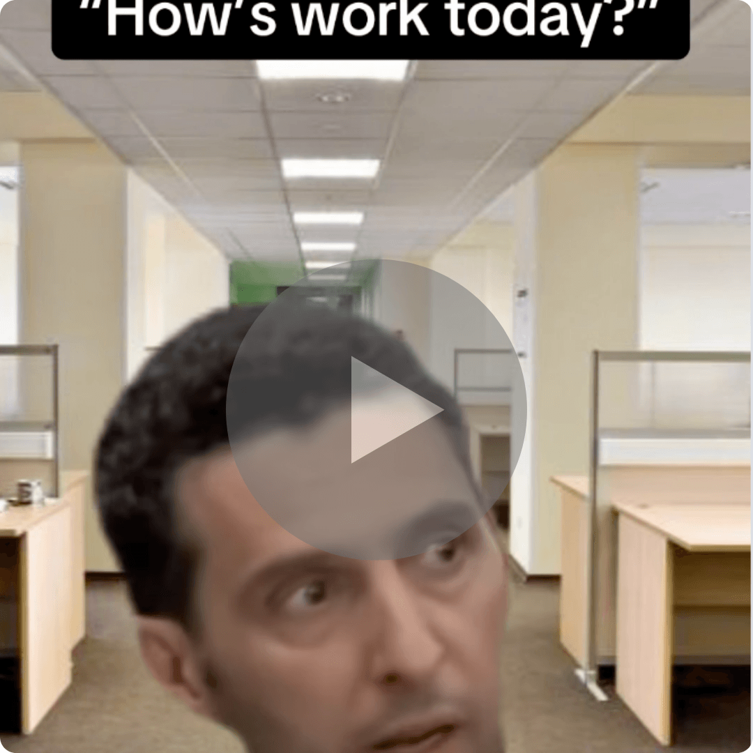 A video thumbnail shows a man looking confused in an empty office filled with desks and cubicles. Text at the top reads, "How's work today?" with a large play button overlay in the center.