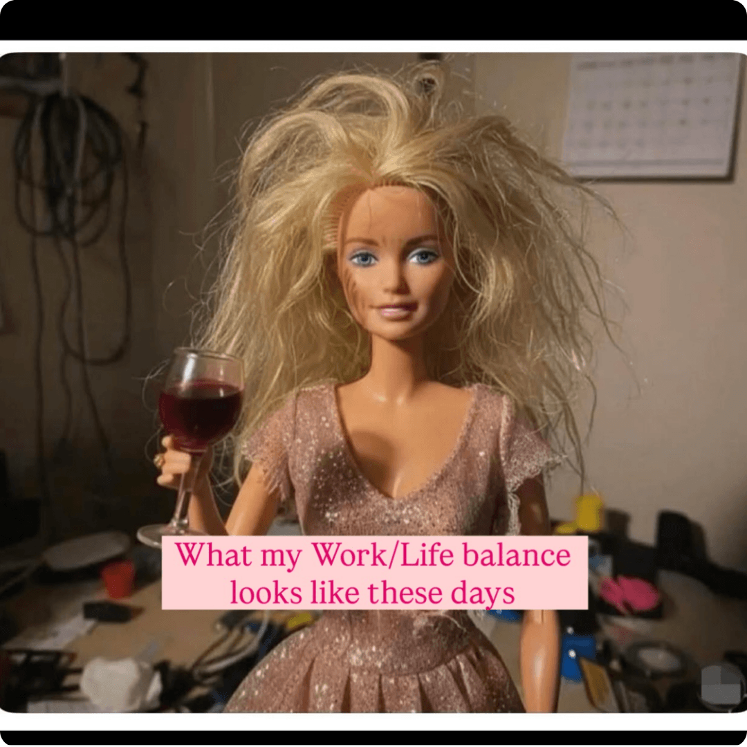 A meme features a disheveled Barbie doll holding a glass of red wine in a cluttered room. Pink text across the bottom reads, "What my Work/Life balance looks like these days.”