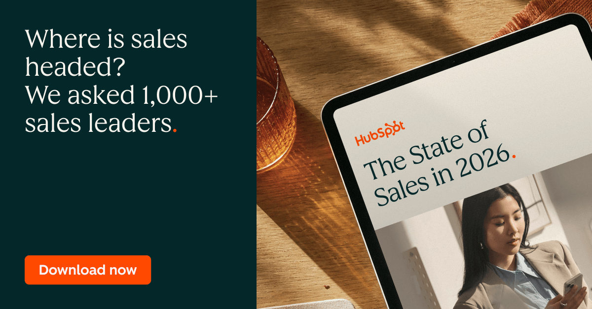 A promotional graphic for HubSpot’s “The State of Sales in 2026” features text inviting readers to discover where sales is headed based on responses from more than 1,000 sales leaders. The design shows a tablet displaying the report cover on a wooden table, with a prominent orange “Download now” button on the left.