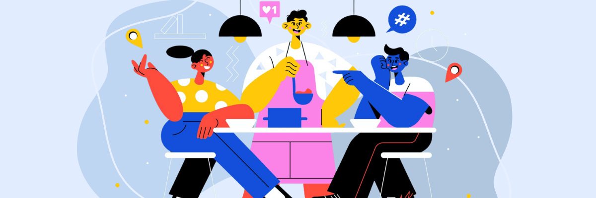 A colorful illustration shows three coworkers sitting around a table sharing a meal and chatting. Hanging lights, speech bubbles, and location icons decorate the background, creating a casual team gathering scene.