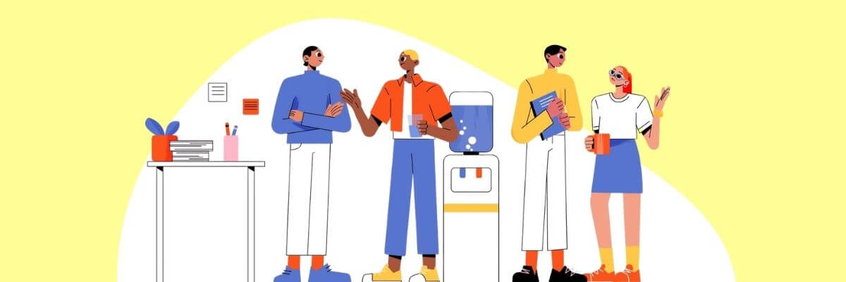 Four illustrated coworkers stand together in a bright office setting, holding notebooks, drinks, and other work materials. A desk with books and stationery sits on the left, while simple blue and orange accents decorate the scene.