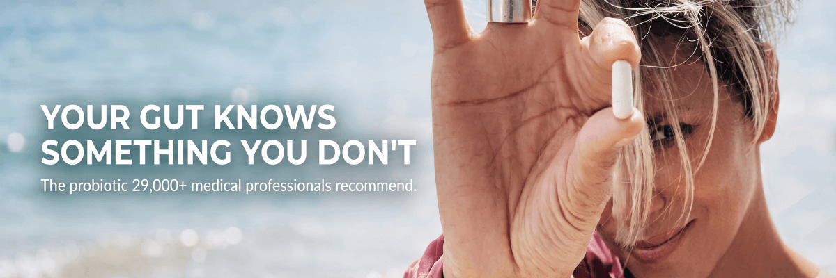 A banner shows a woman holding a white capsule near her face with a blurred seaside background behind her. White text on the left reads, “YOUR GUT KNOWS SOMETHING YOU DON’T,” followed by a line about a probiotic recommended by more than 29,000 medical professionals.