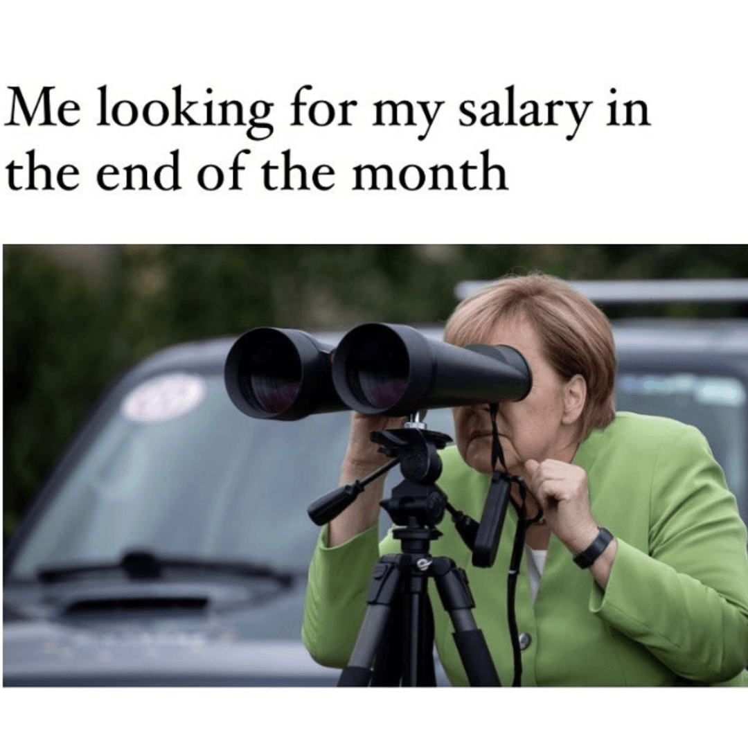 A meme shows a person looking through large binoculars mounted on a tripod beside a parked vehicle. The text reads, “Me looking for my salary in the end of the month.”