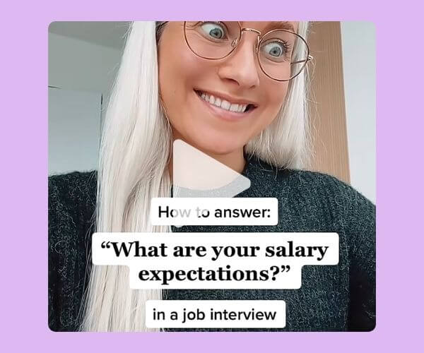 A smiling woman wearing glasses appears in a close-up video frame. Text over the image reads, “How to answer: ‘What are your salary expectations?’ in a job interview.”