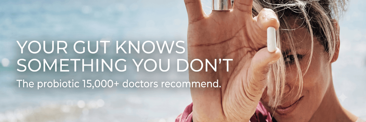 A photo of a person holding a white capsule in front of their face, with a beach and blue sky in the background. White text reads, “YOUR GUT KNOWS SOMETHING YOU DON’T,” followed by “The probiotic 15,000+ doctors recommend.”