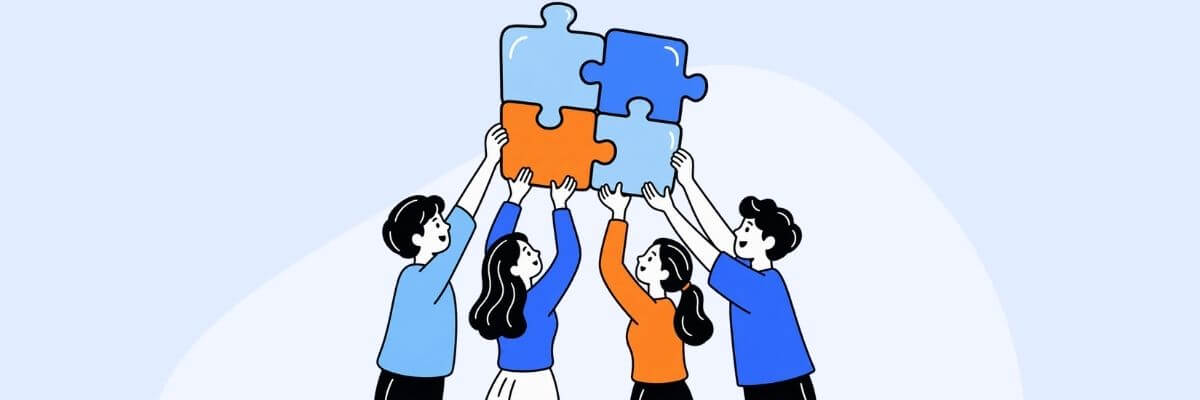 A light blue illustration showing four people reaching upward with colorful puzzle pieces. The pieces are being fitted together above the group.