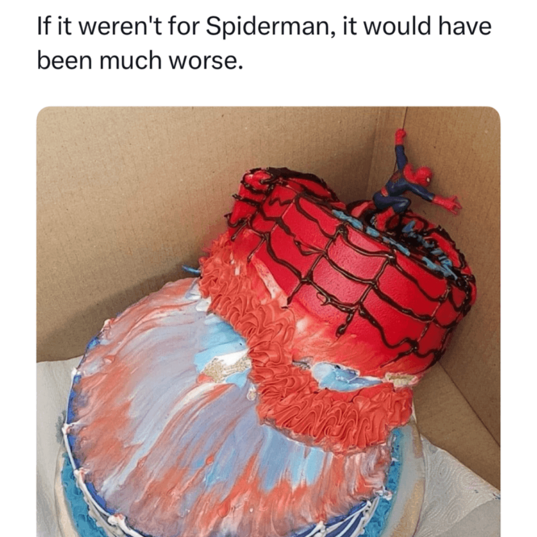 White background with text reading, “If it weren't for Spiderman, it would have been much worse.” Below the text is a red, blue, and white decorated cake topped with several Spider-Man figures inside a cardboard box.