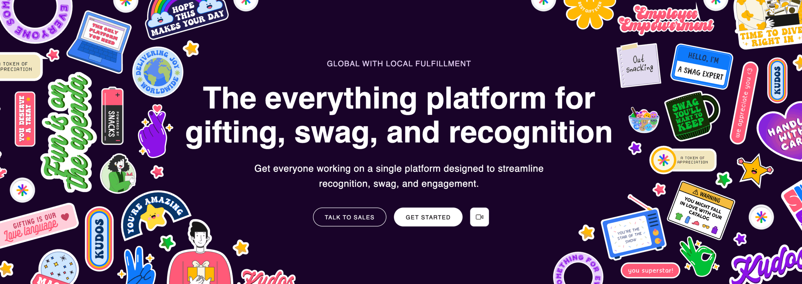 A bold website banner uses a deep purple background with colorful sticker-style illustrations scattered around the edges. The center features large white text, “The everything platform for gifting, swag, and recognition,” with supporting text and “Talk to Sales” and “Get Started” buttons below.